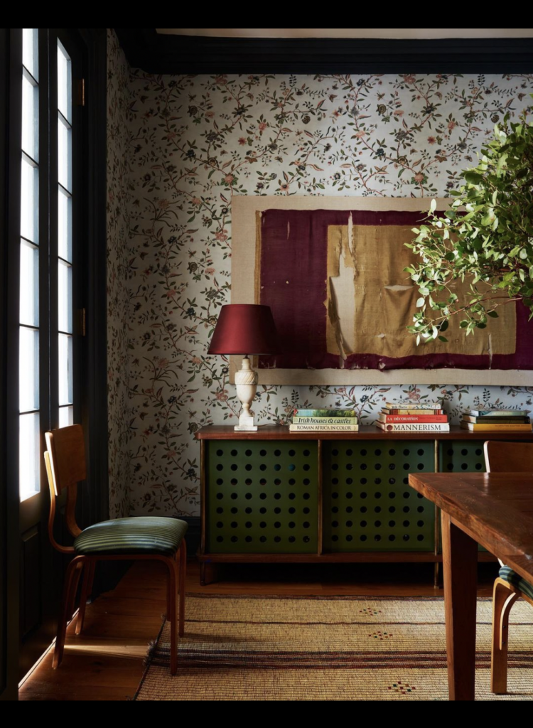 green dining room with wallpaper and vintage marble lamp