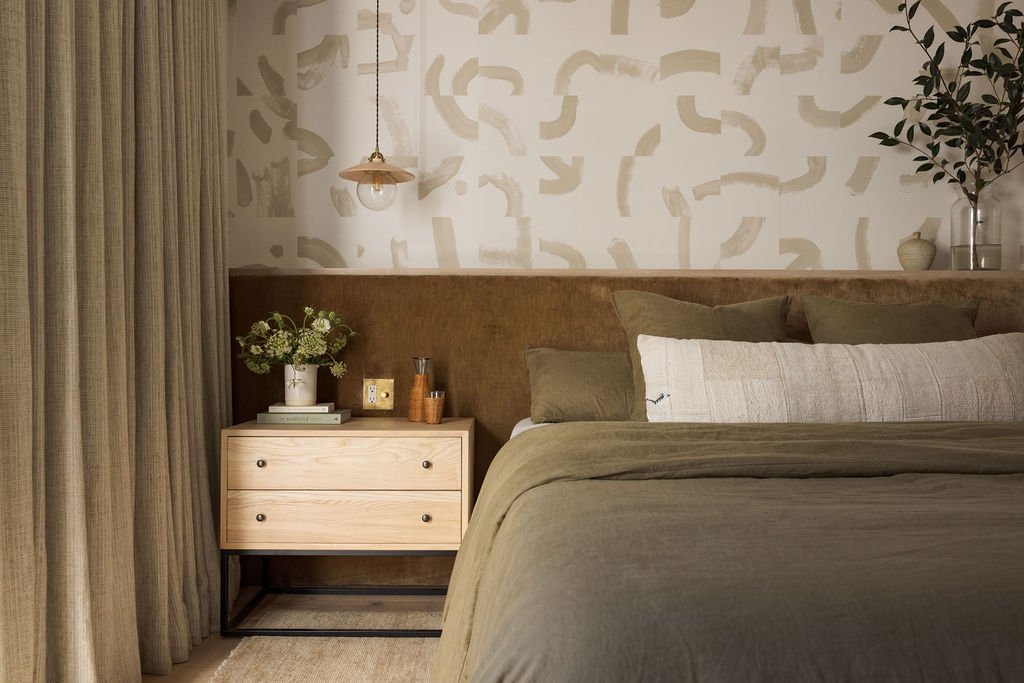 Designer nightstand in moody green bedroom