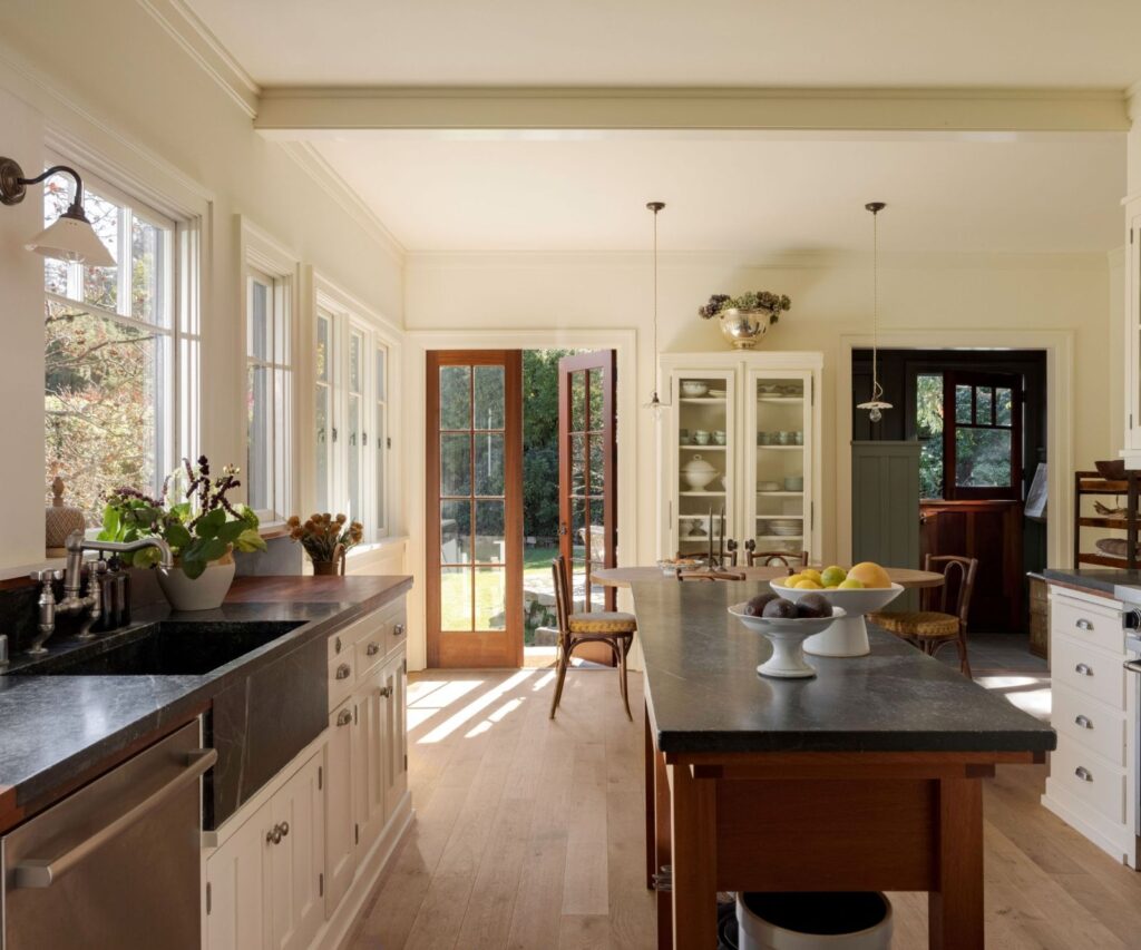An English-Style Home in California with white shaker cabinets and butcher block counters and soapstone accents
